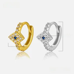 Macro view of evil eye earrings with zircons in gold and silver showing precise dimensions