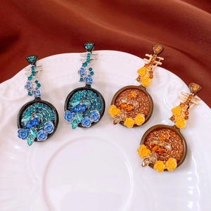 Macro shot of vintage style musical instrument brooches with crystals and enamel flowers