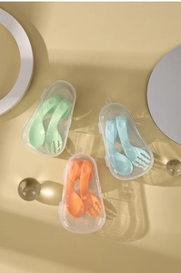 Portable baby training fork and spoon sets in green, blue and orange storage boxes