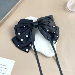 Elegant black satin bow hair clip with white pearls, black feathers and long ribbons
