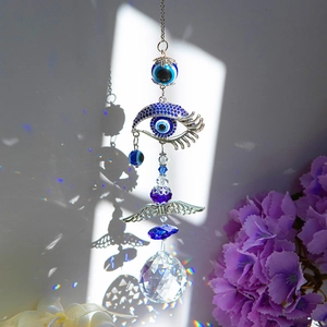 Detail of Turkish evil eye suncatcher with crystal prism ball throwing rainbow light