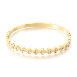 Minimalist gold cross flower bangle with sparkling zircon stones on a white background