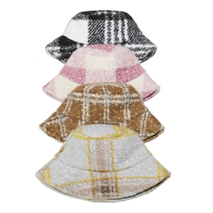 Detail view of four checkered teddy fleece bucket hats in various vintage color patterns