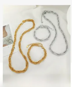 Close-up of interlocking woven chain necklaces and bracelets in gold and silver finish