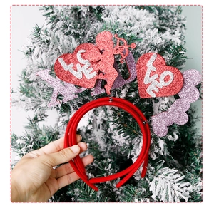 Detail of red glitter heart headband with Cupid silhouette for Valentine's Day party decor