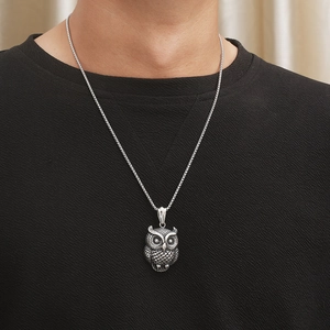 Vintage punk owl pendant necklace in aged stainless steel for men on black background