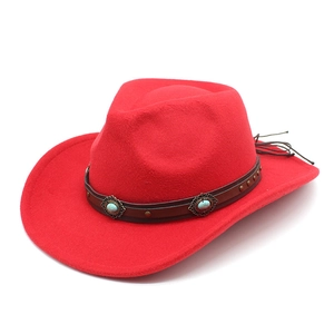 Detail of red western cowboy hat with turquoise and bronze studded leather band