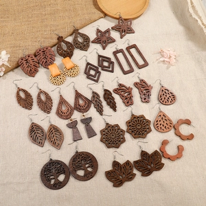 Collection of hollow wood geometric earrings including leaf and tree of life designs