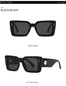 Detail of black rectangular sunglasses with golden ring accent and metal dots on frames