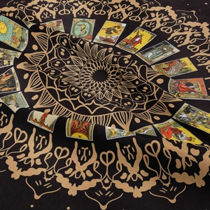 Bohemian moon phase tapestry with gold mandala and tarot cards on black fabric