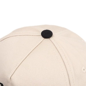 Macro shot of cotton twill crown construction with black button detail and neat stitching
