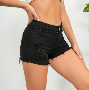 Vista laterale di pantaloncini in denim nero consumato con strappi e orlo a frange