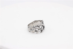 Close-up of gothic silver titanium steel ring with unique hollow dragon flame textures