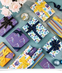Flat-lay display of colorful cartoon monster gift wrapping paper for birthdays