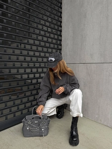 Street style view of grey polar fleece zip hoodie with letter embroidery and crossbody bag