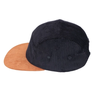 Detail of a vintage 5-panel hat with black corduroy crown and tan suede flat brim texture