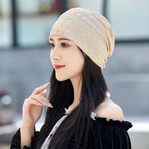 Elegant beige lace beanie with sparkling rhinestones for women shown on a model side view