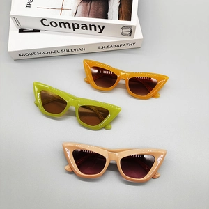 Retro cat-eye sunglasses in orange, green and pink candy colors with dark UV lenses