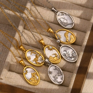 Detailed flat lay of gold and silver 12 zodiac pendant necklaces with shell inlay