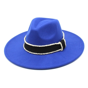 Detail of royal blue wool felt fedora featuring a black ribbon with pearl bead accents