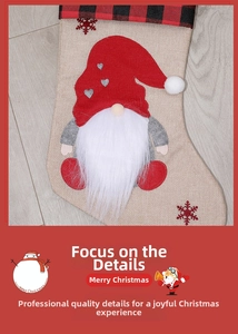 Detail of burlap Christmas stocking featuring a gnome with heart-patterned red hat and snowflakes