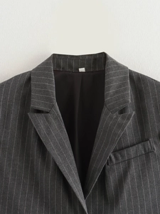 Detailed close-up of grey pinstripe vest collar and lapel with premium woven texture