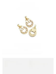Detail showing 18K gold-plated butterfly pendant with seed pearls and natural shell inlay