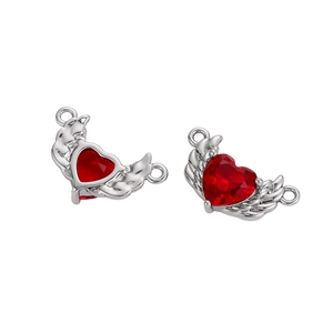 Detailed view of silver angel wing charms with red heart stone for jewelry making