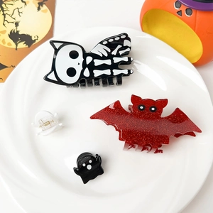 Detailed set of Halloween hair claws featuring pumpkin bat and ghost acrylic designs