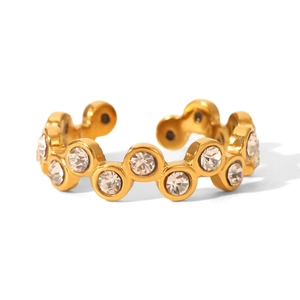 Macro shot of gold-plated wavy ring featuring cubic zirconia in circular bezel settings