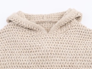 Close-up of thick knit beige hoodie sweater showing high-quality soft wool texture