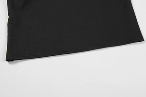 Detailed close-up of high-quality double-needle stitching on a black knitted dress