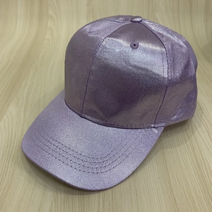 Detail view of purple metallic baseball cap with shimmering texture and embroidered eyelets