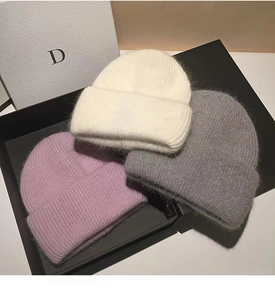 Detailed view of three soft angora rabbit fur knit hats in a gift box for winter