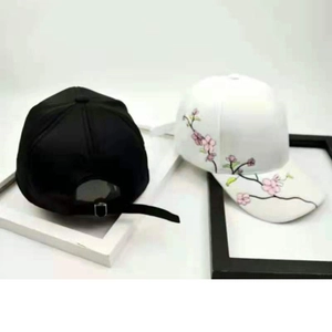 Vintage embroidered baseball caps with plum blossom pattern and metal buckle detail