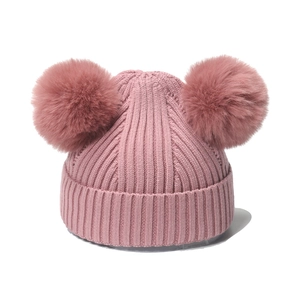 Pink rib-knit children's winter hat set with dual fluffy faux fur pom poms and thick texture