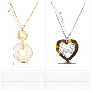 Detail view of round shell inlay pendant and heart-shaped resin necklace with LOVE crystals