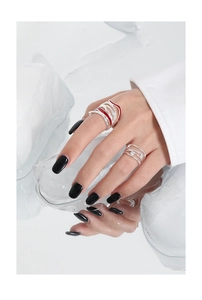 Macro detail of textured silver open ring with red enamel inlay and micro pave stones