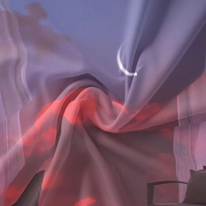Detailed macro view of the flowing bohemian fabric with moon and sunset sky print