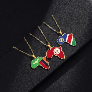 Detail of African map pendants with Namibia, Tunisia, and Zambia flags on gold chains