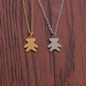 Polished bear pendant necklaces in gold and silver finish on a dark wood background