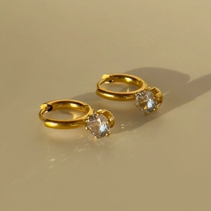 Macro shot of 18k gold plated hoop earrings featuring sparkling round zircon pendants