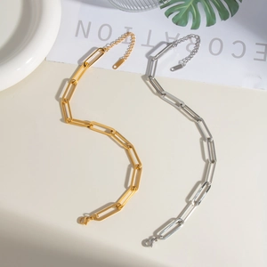 Detail of paperclip link chains in gold and silver finish with lobster clasp closure