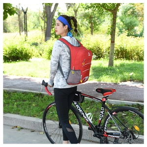 Detailed view of red cycling backpack with breathable mesh and reflective safety strips
