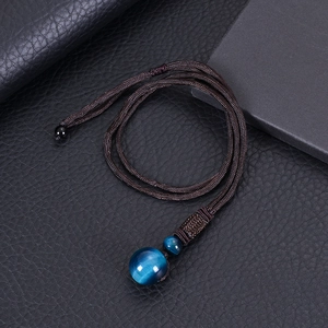 Macro shot of 16mm blue tiger eye stone pendant with handcrafted woven brown rope