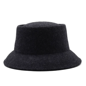 Close-up of dark grey wool felt bucket hat showing dense fiber texture and minimalist design