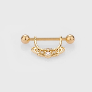 Vue détaillée d'un anneau de mamelon doré avec pendentif filigrane et pierres claires