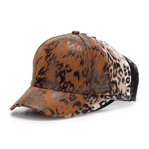 Detailed view of three leopard print baseball caps in brown and grey textured fabric