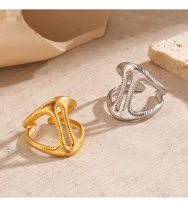 Detailed view of hollow geometric stainless steel rings with textured ribbed surfaces