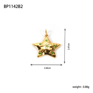 Macro shot of gold star pendant with green rhinestones and precise size measurements